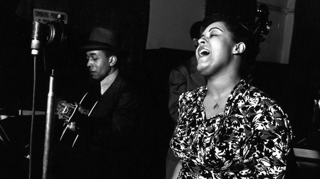 Billie Holiday sings on stage.