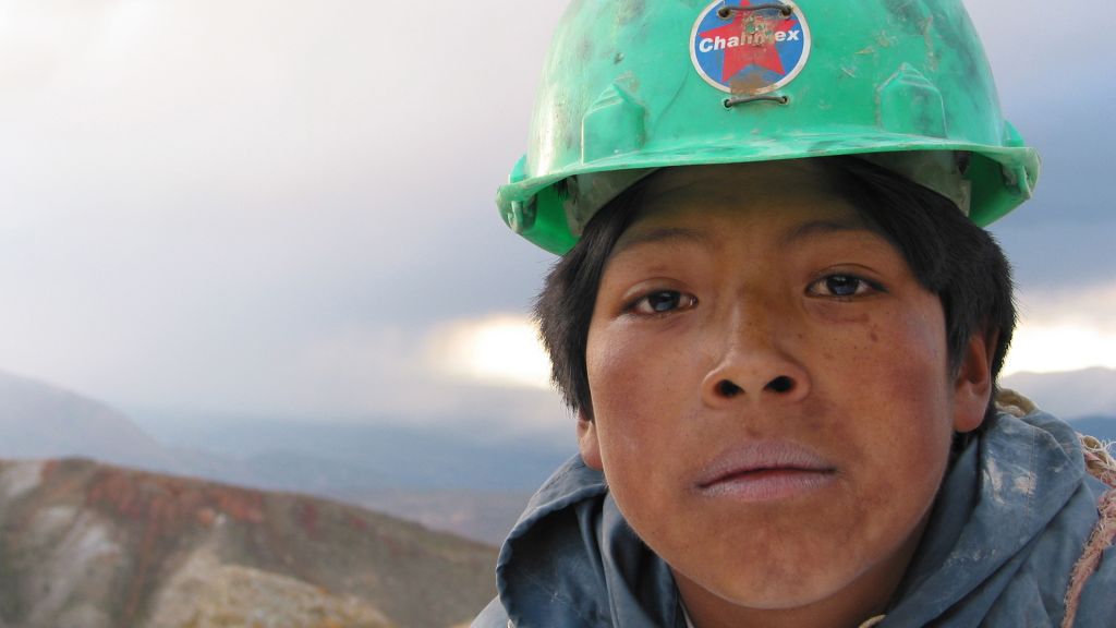 Close-up of a 14-year-old Bolivian boy staring directly at the camera