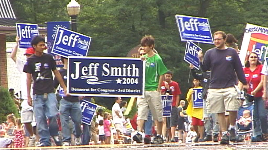 A group of people, some holding signs reading Jeff Smith 2004