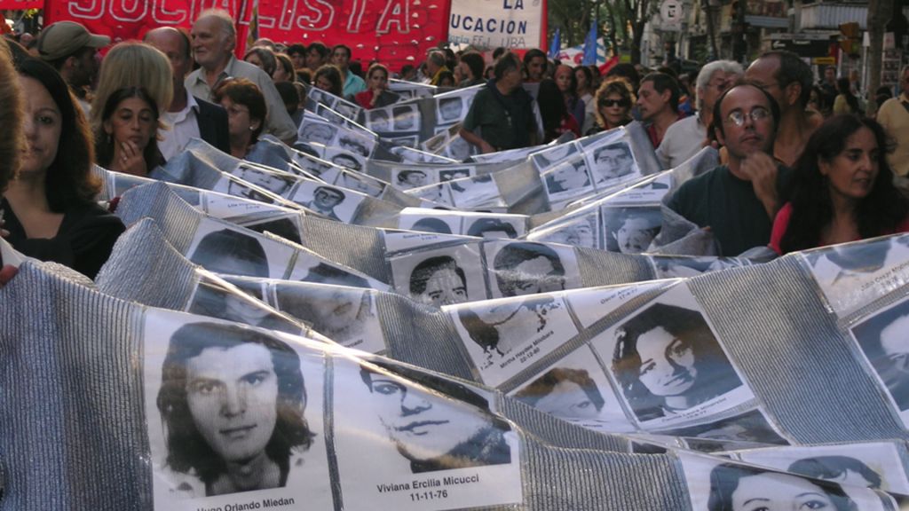 Banner with pictures of the Argentine disappeared carried by relatives