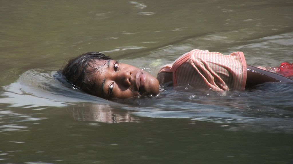 Young Filipina woman named Margarita swimming, in Left by the Ship