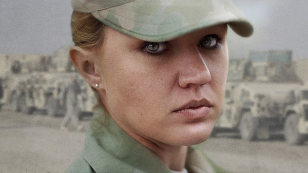 A female soldier wearing military fatigues looks over her shoulder into the camera.