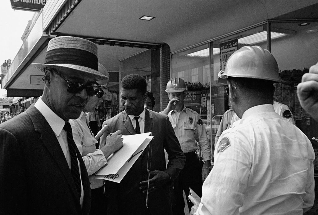 Civil Rights activists are confronted by police.