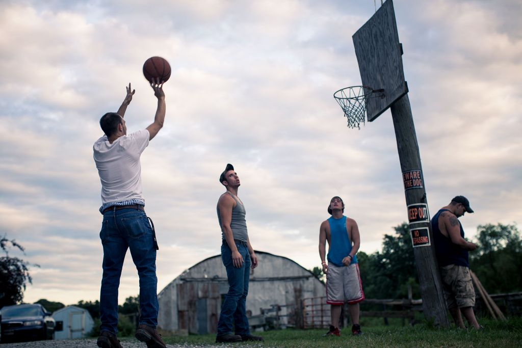 Kids of Medora shooting basketball outside in their street clothes