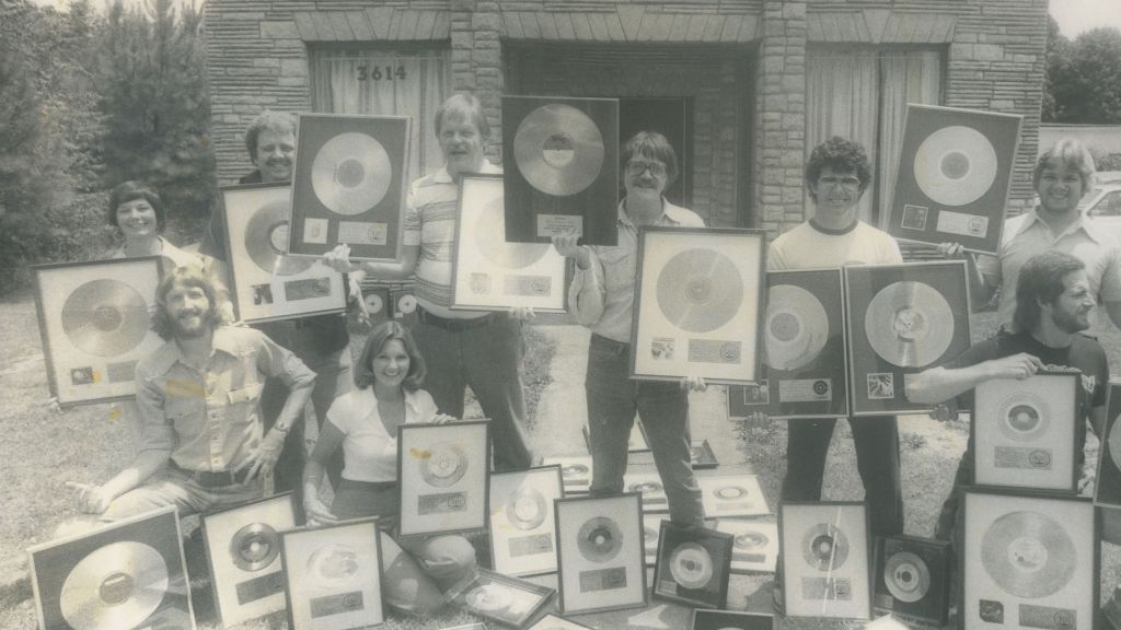 Muscle Shoals staff displaying their gold records.