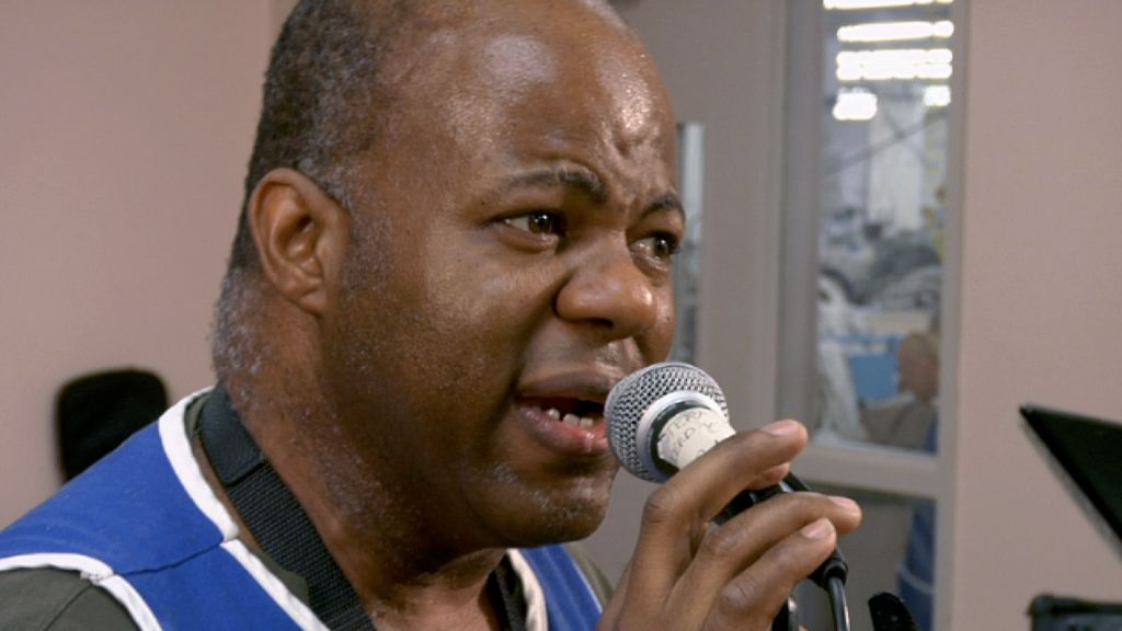 A man sings into a microphone.