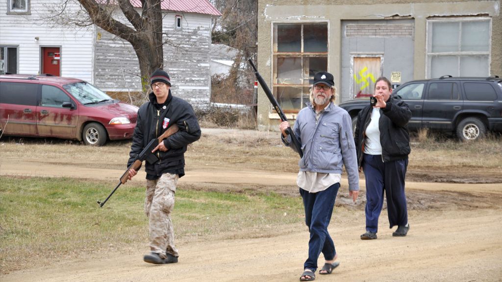 White supremacist Craig Cobb and his followers march through Leith, North Dakota with their rifles.