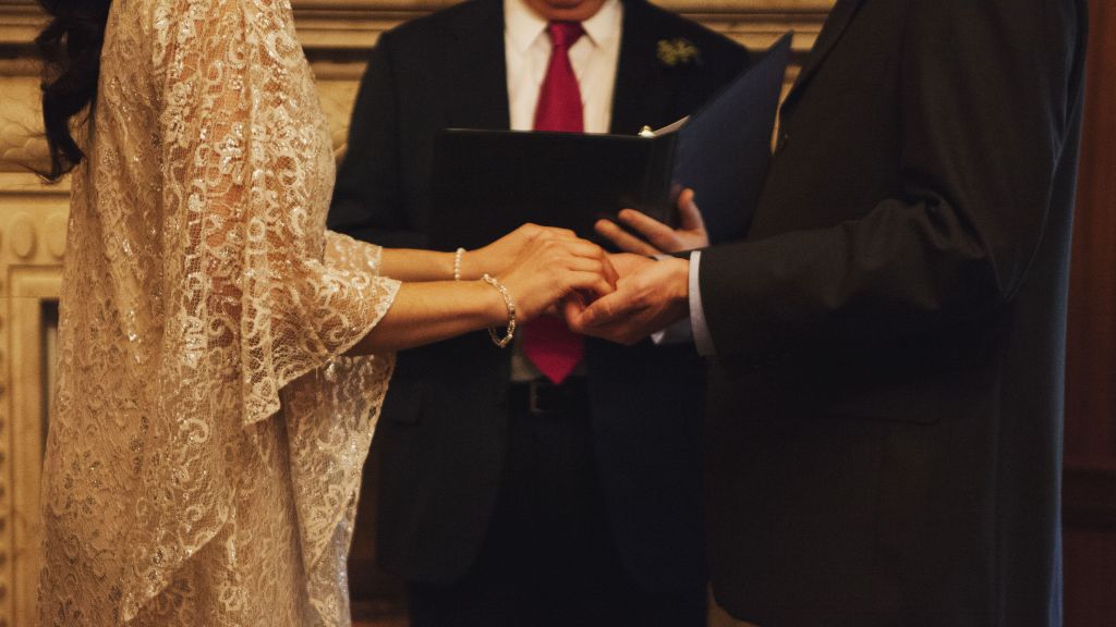 Dave and Lindsey's hands joined together in an exchange of wedding vows.