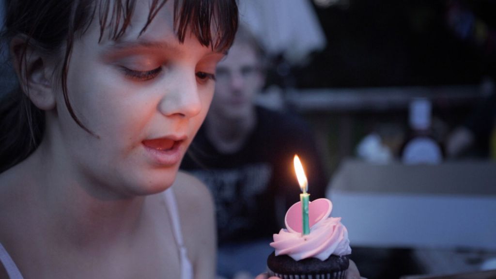 Michelle Smith blows out birthday candle, in Best and Most Beautiful Things