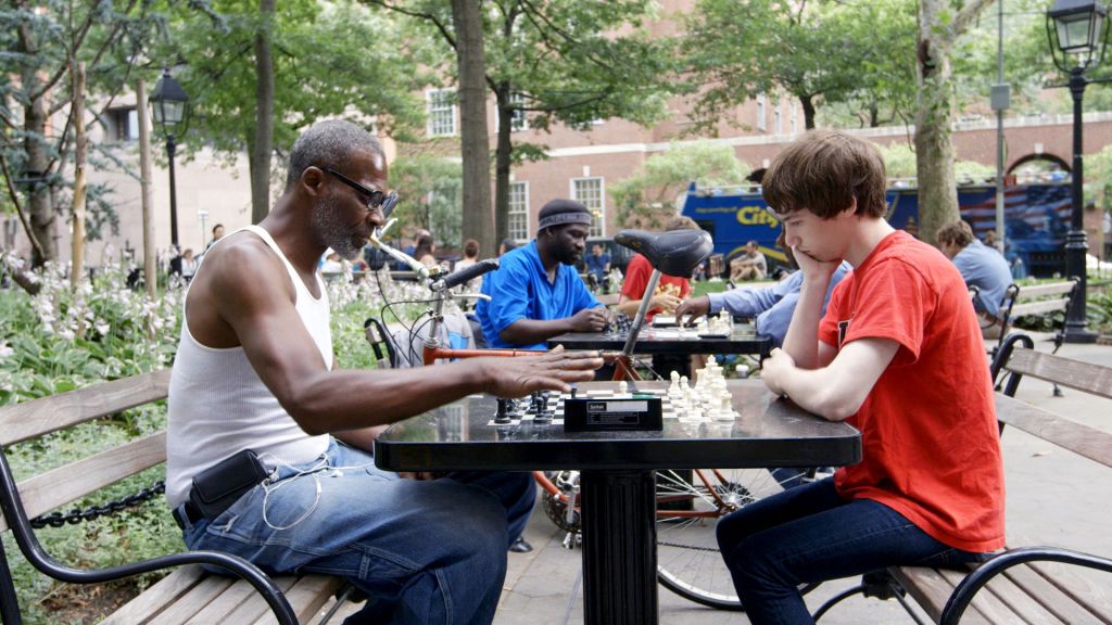 From Prison in Six Landscapes, a man and boy play chess outside a prison