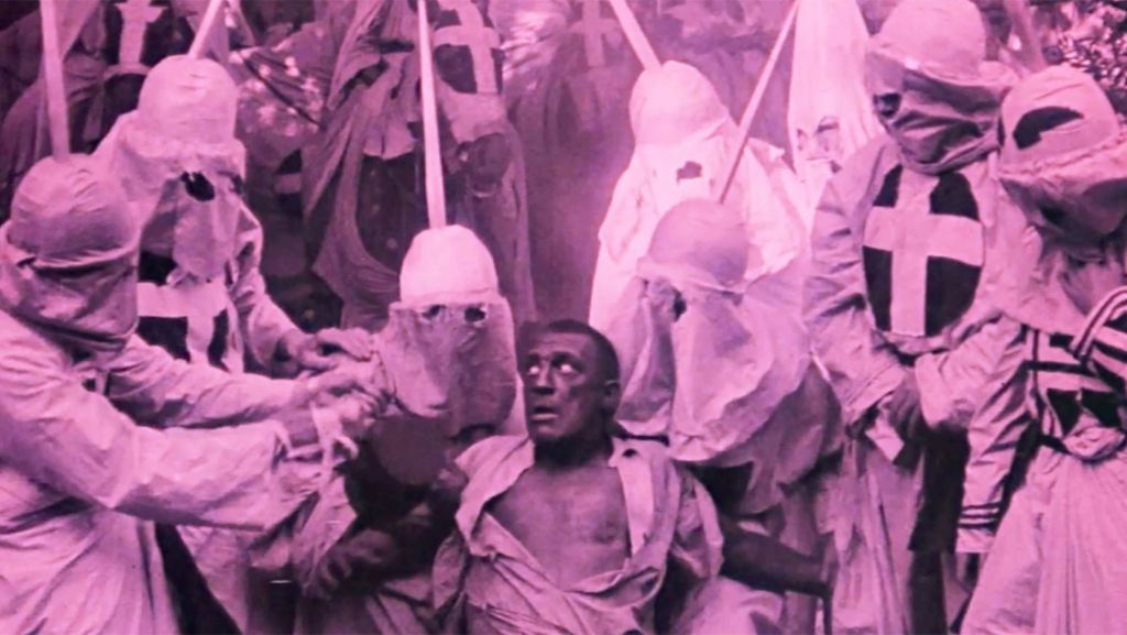 scene from Griffith's Birth of a Nation wherein the Klan surround a "mulatto man" (played by a white actor in blackface), in the film Birth of a Movement