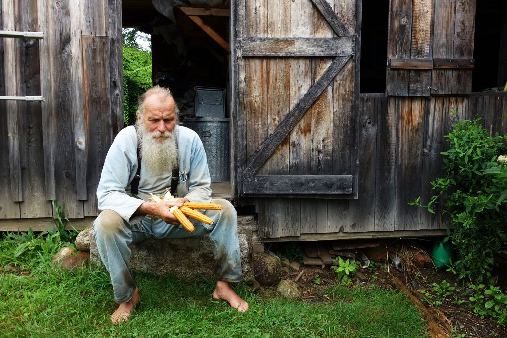 Will Bonsall, seed saver and organic farmer holds endangered corn seeds on his farm and seed bank in Industry, Maine.