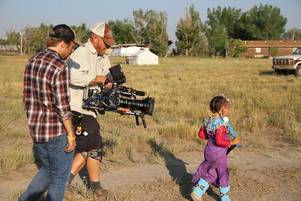 Wind River Director, Mat Hames, and DP, Wilson Waggoner, film a Northern Arapaho child at the Ethete Powwow.