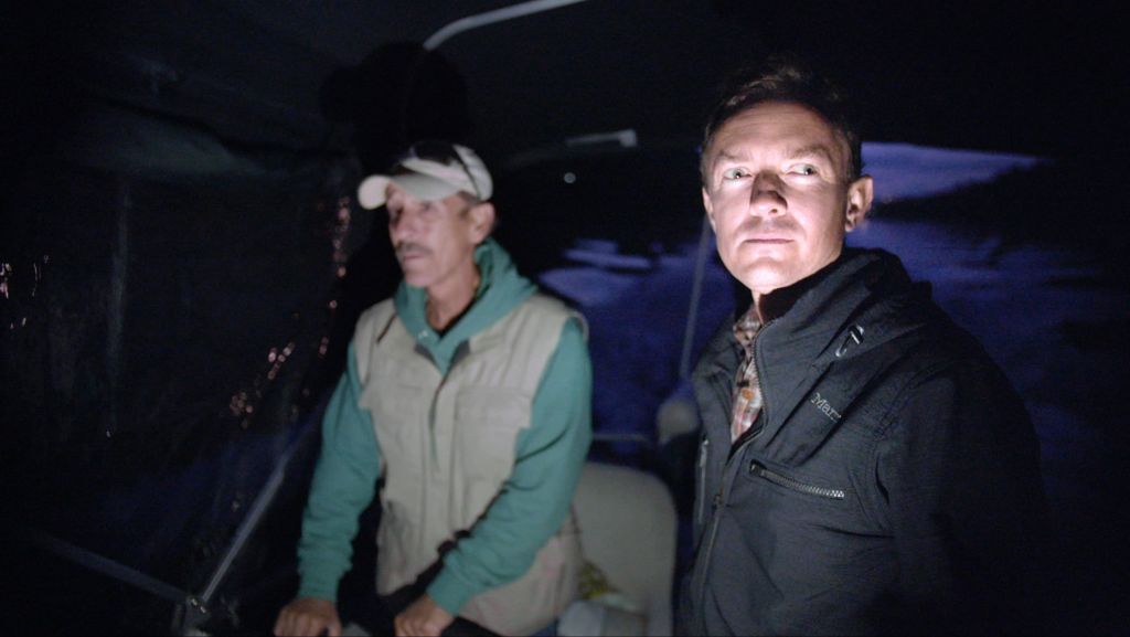 Director Cullen Hoback (at right) takes secret charter up West Virginia river to collect water samples under the cover of night.