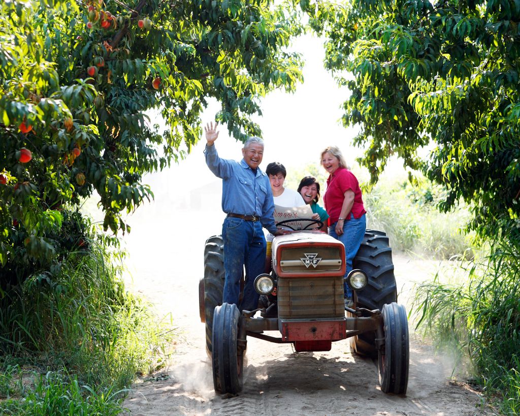 The Masumoto family farmers on a tractor in the Central Valley California peach farm