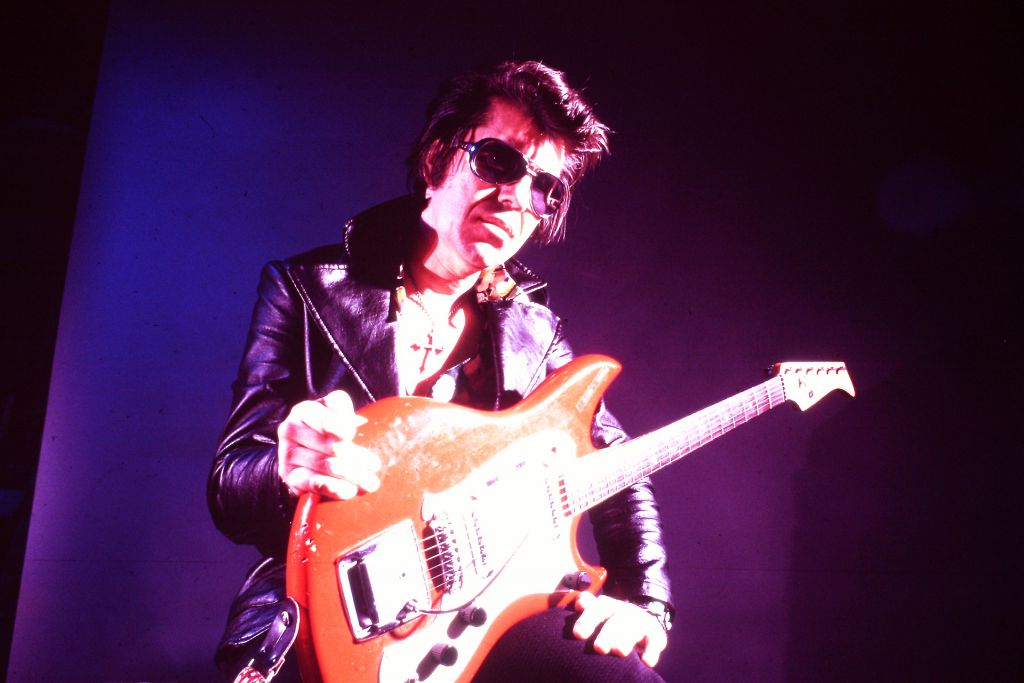 Link Wray on stage with guitar, from RUMBLE