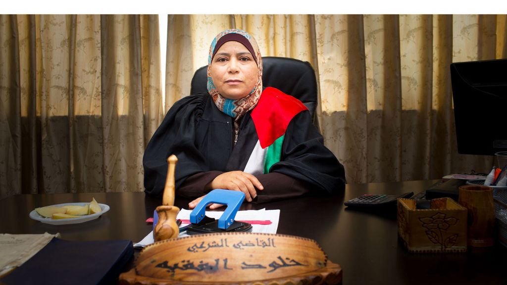 Judge Kholoud behind desk in The Judge