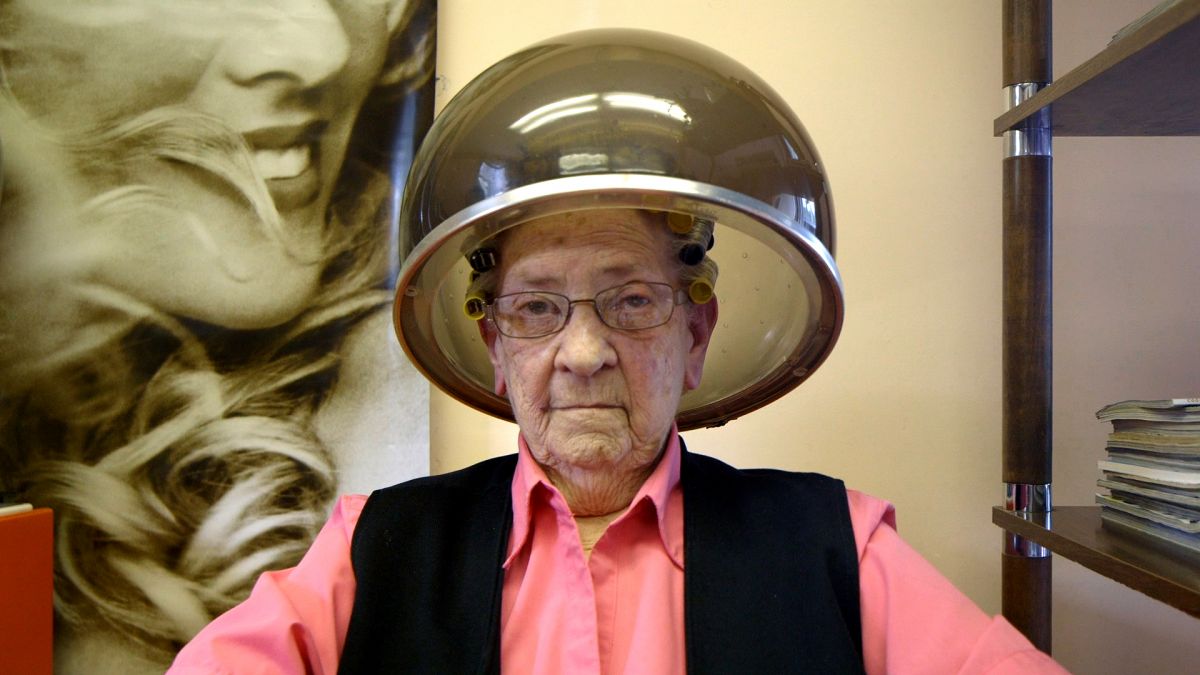 Elderly woman getting a perm at the salon