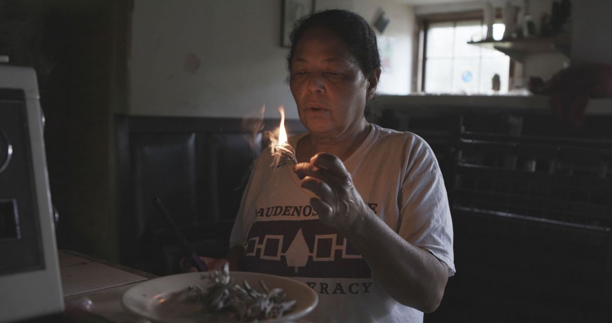  Rebecca Hill-Genia, a Shinnecock activist, holding a match during a lighting ceremony in the Hamptons, NY