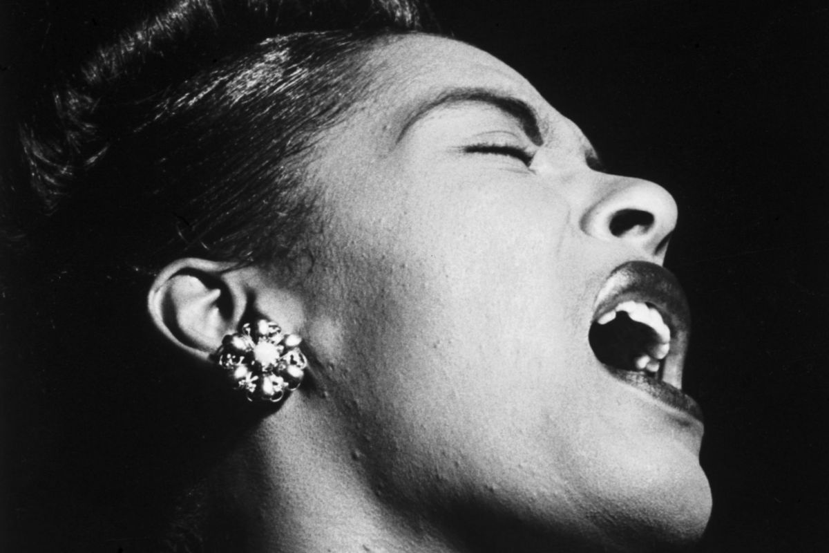 A black and white photo of Billie Holiday singing mid-note.