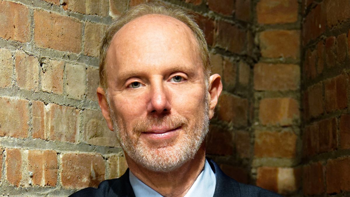 Headshot of producer/director Kenneth Rosenberg, a man with light skin tone and gray hair and beard.