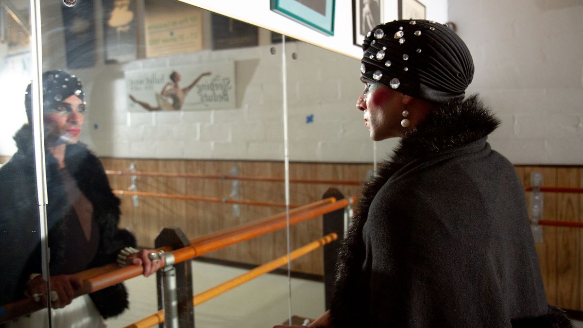 Michael standing in front of a mirror looking at his reflection.