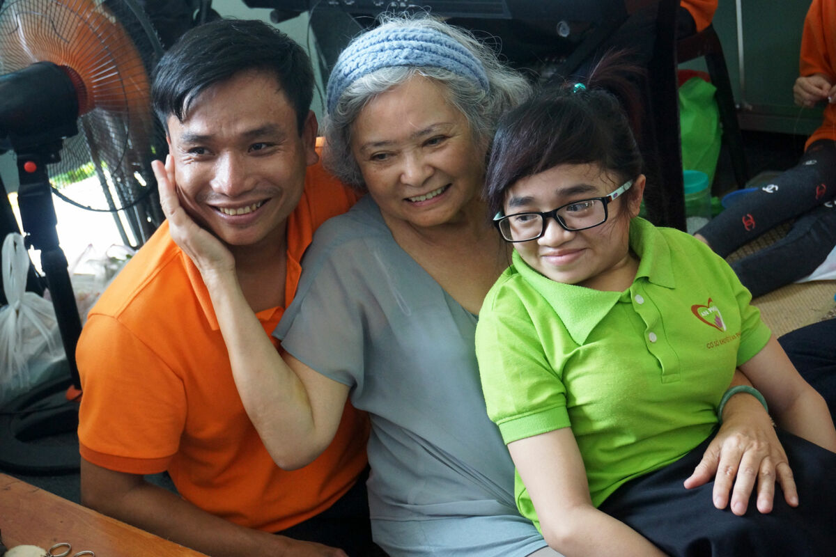 Tran To Nga sits with victims of Agent Orange at the War Remnants Museum in Ho Chi Minh City, Vietnam