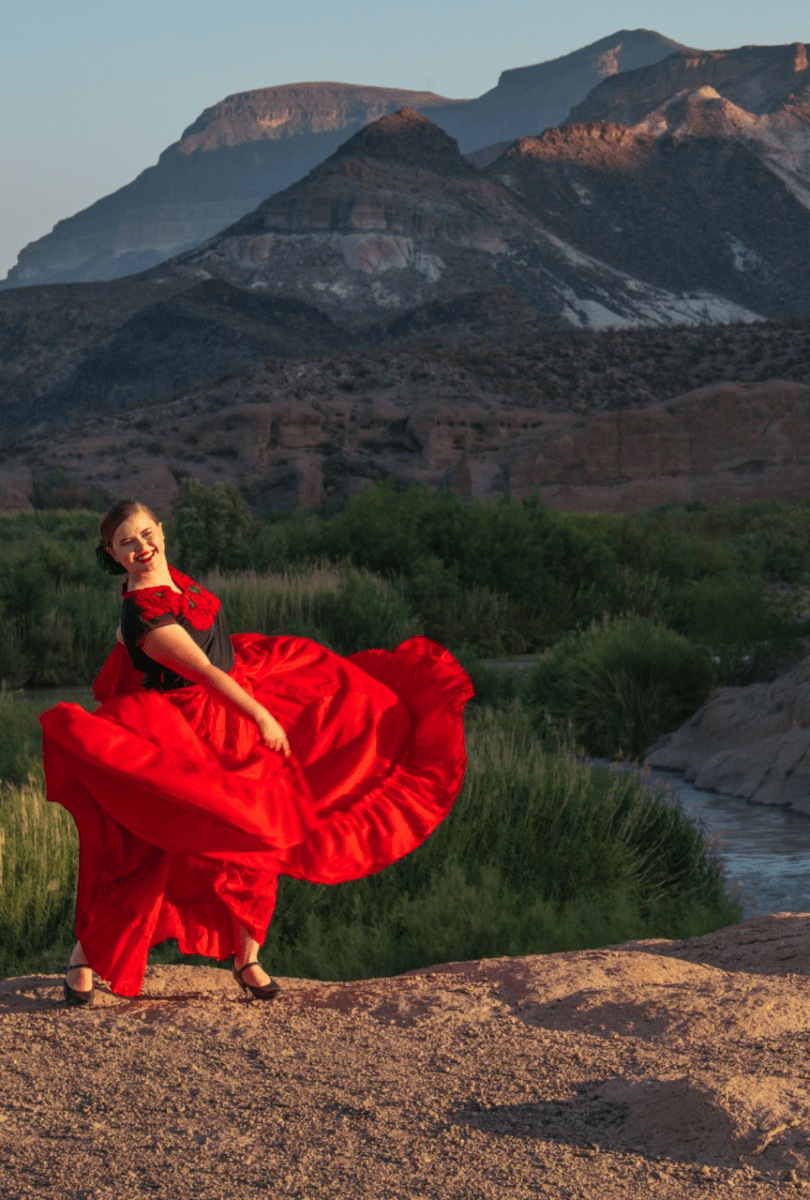 Woman in dress dancing and smiling