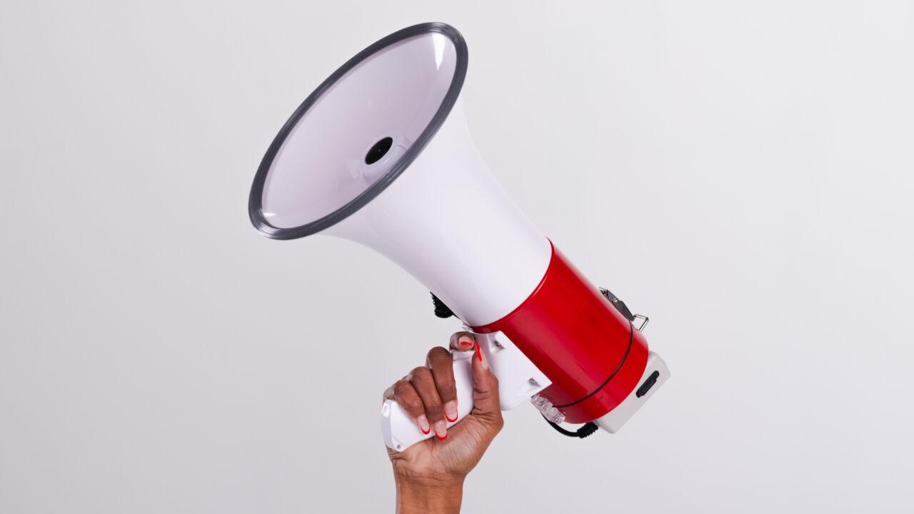 Hand holding megaphone in the air