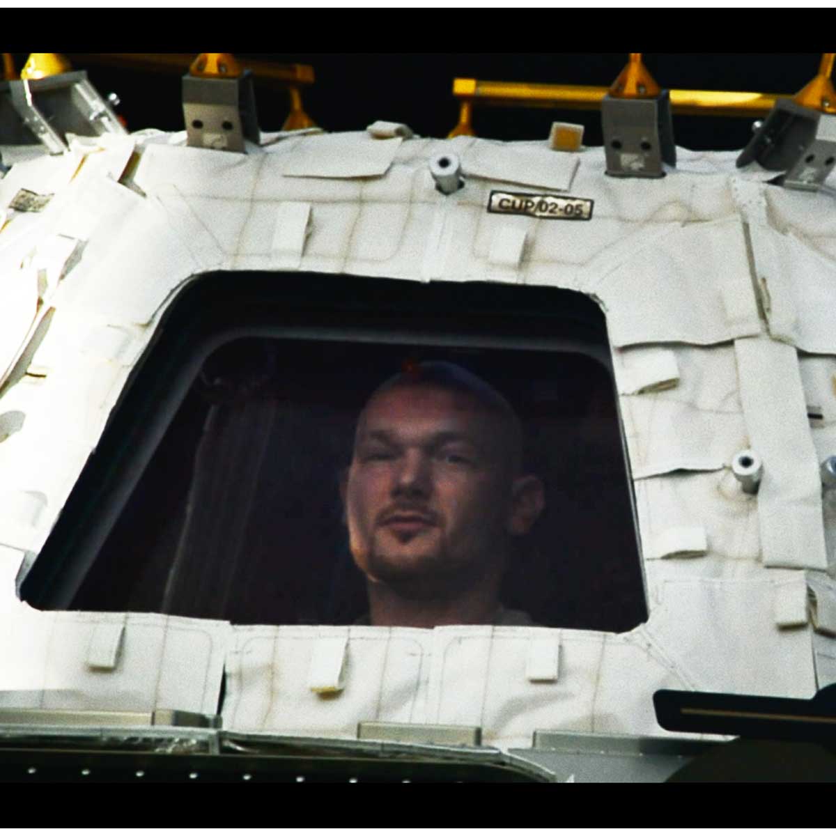 German astronaut Alex Gerst looks out of the window of a space station.