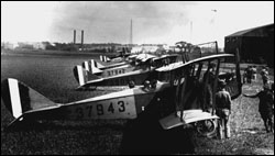 Early twentieth-century biplane on field (period photo)