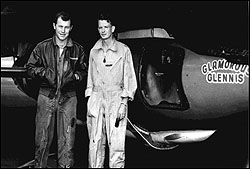 Yeager and Ridley, posing in front of X-1 as it's slung under parked B-29