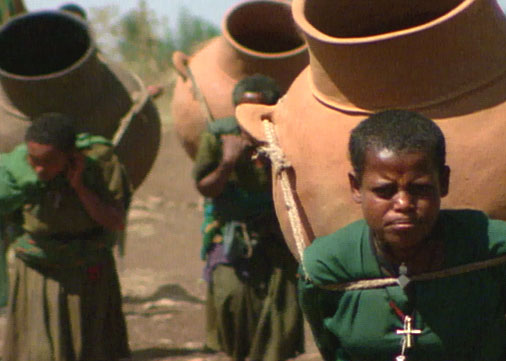 Women carrying clay pots