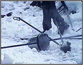 The radioactive device and its containment bucket with handles.