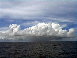 Storm cell over ocean, in distance