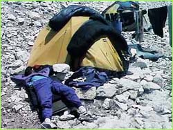 Tired Climber sleeping beside tent