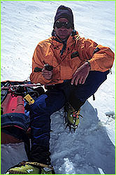 David Breashears sitting in snow at altitude