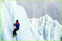 climber rapelling down ice face