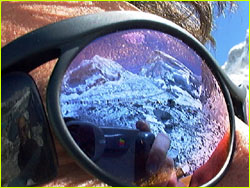 Closeup of sunglasses with mountain in reflection