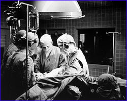 Surgeons performing open heart surgery