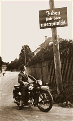 Motorcyclist and sign